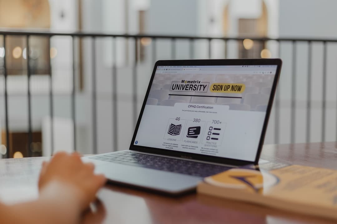 person using macbook pro on brown wooden table