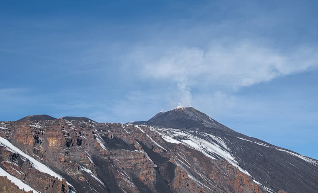 brown and white mountain under blue sky during daytime