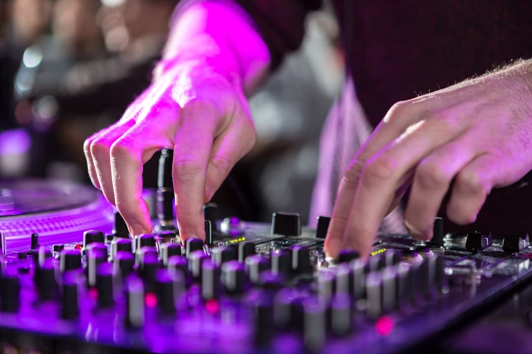 person in purple long sleeve shirt playing black audio mixer