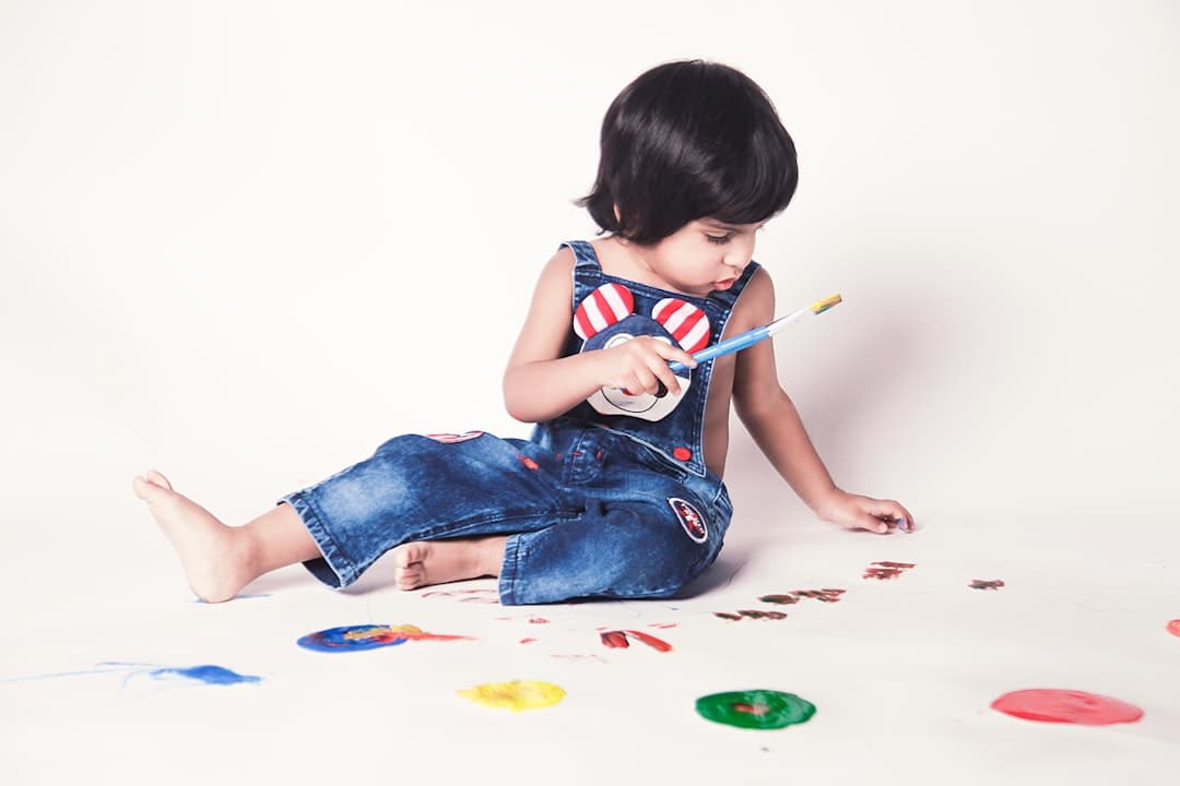 girl in blue denim shorts sitting on white floor