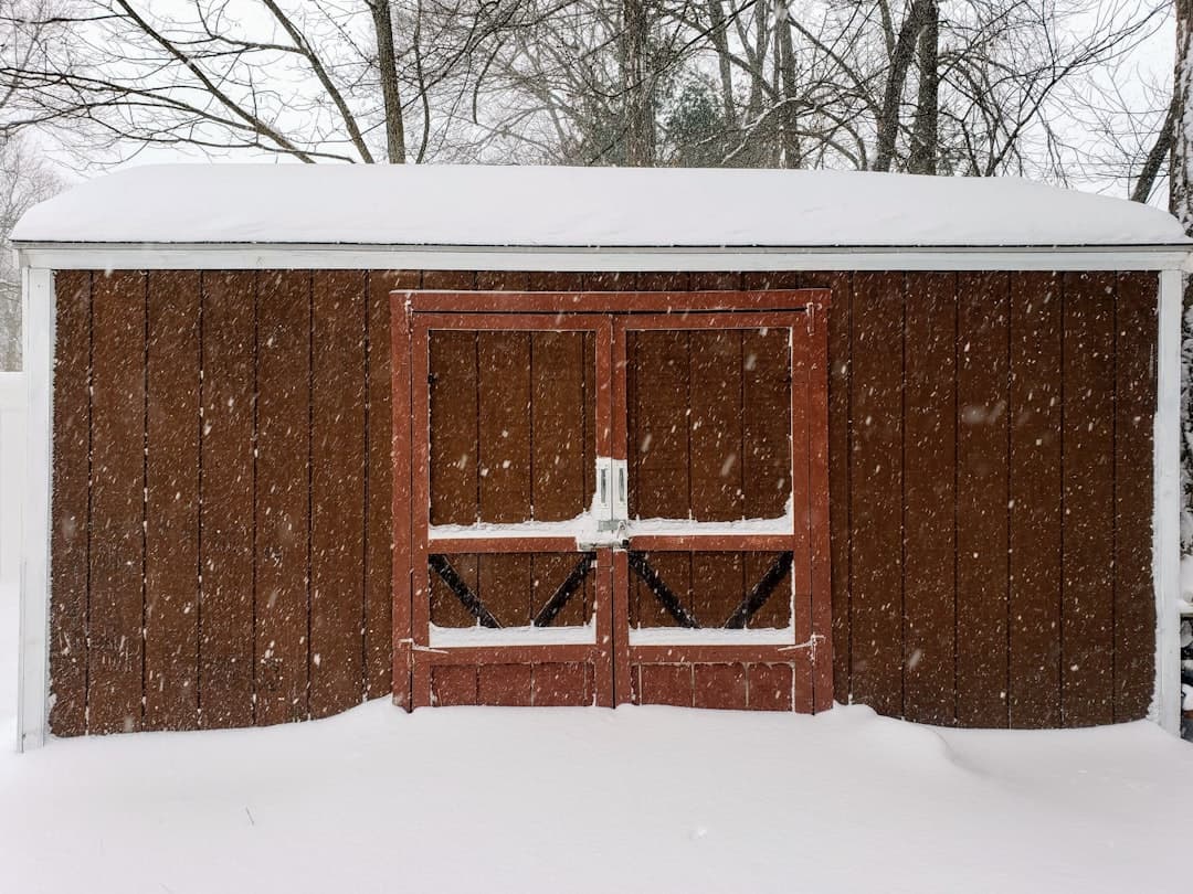 brown wooden house covered with snow