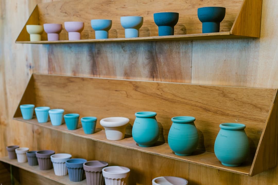 blue ceramic vase on brown wooden table