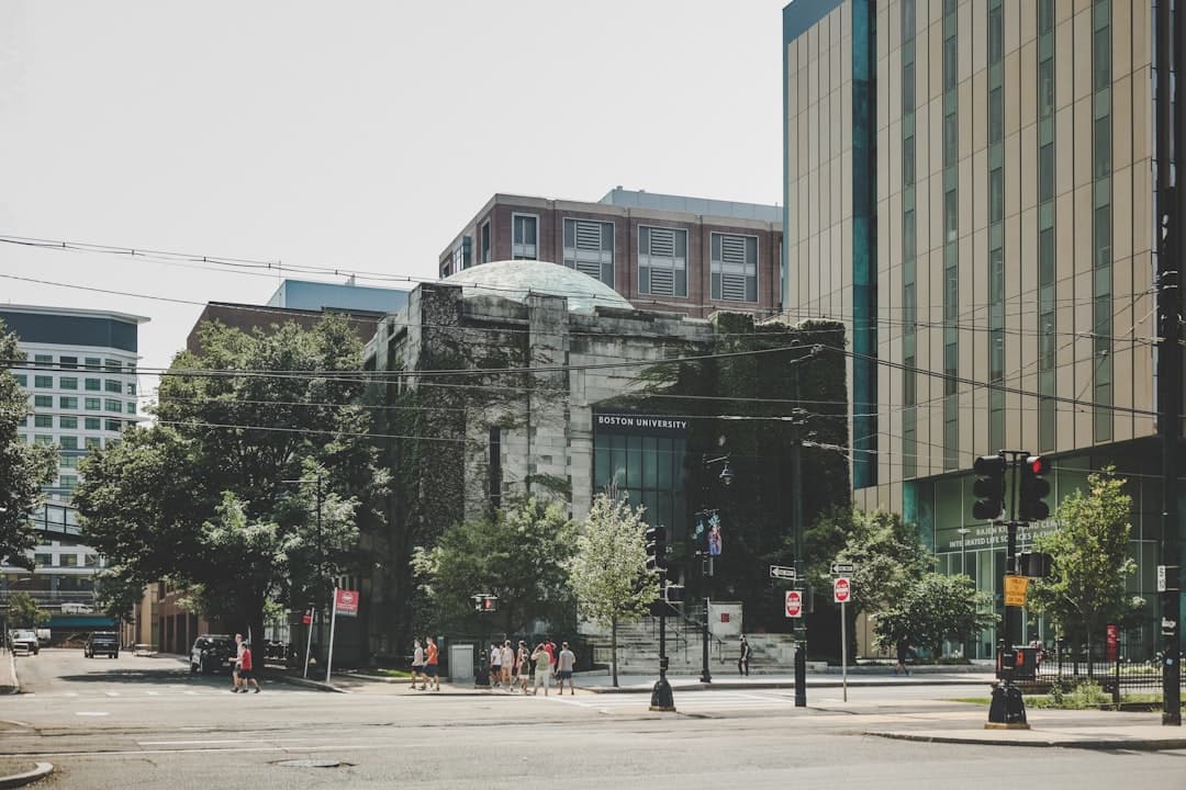 people walking on sidewalk near building during daytime