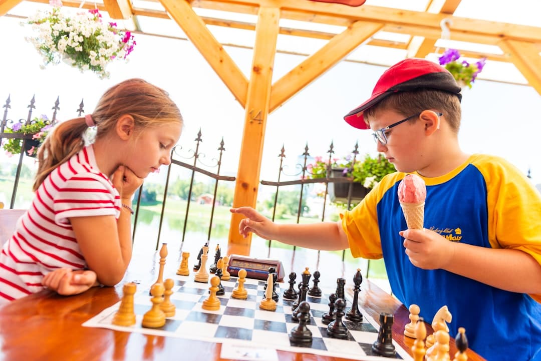 boy in blue t-shirt playing chess