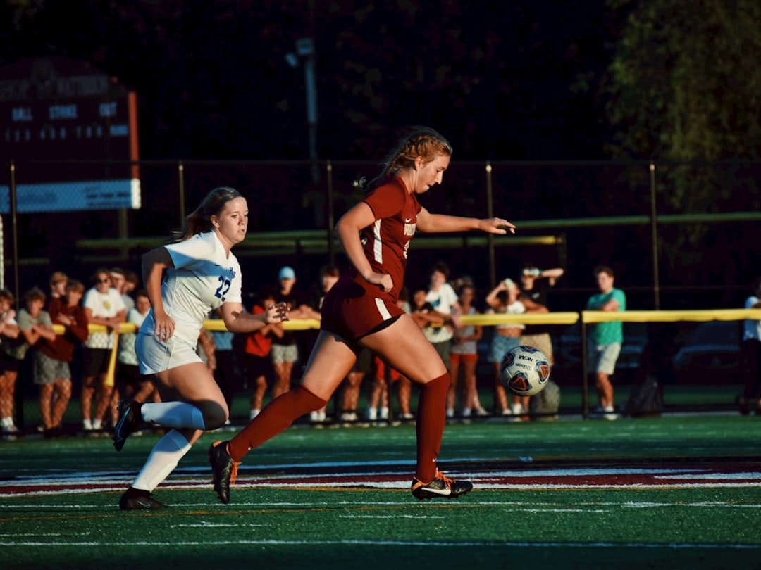 women playing soccer during daytime