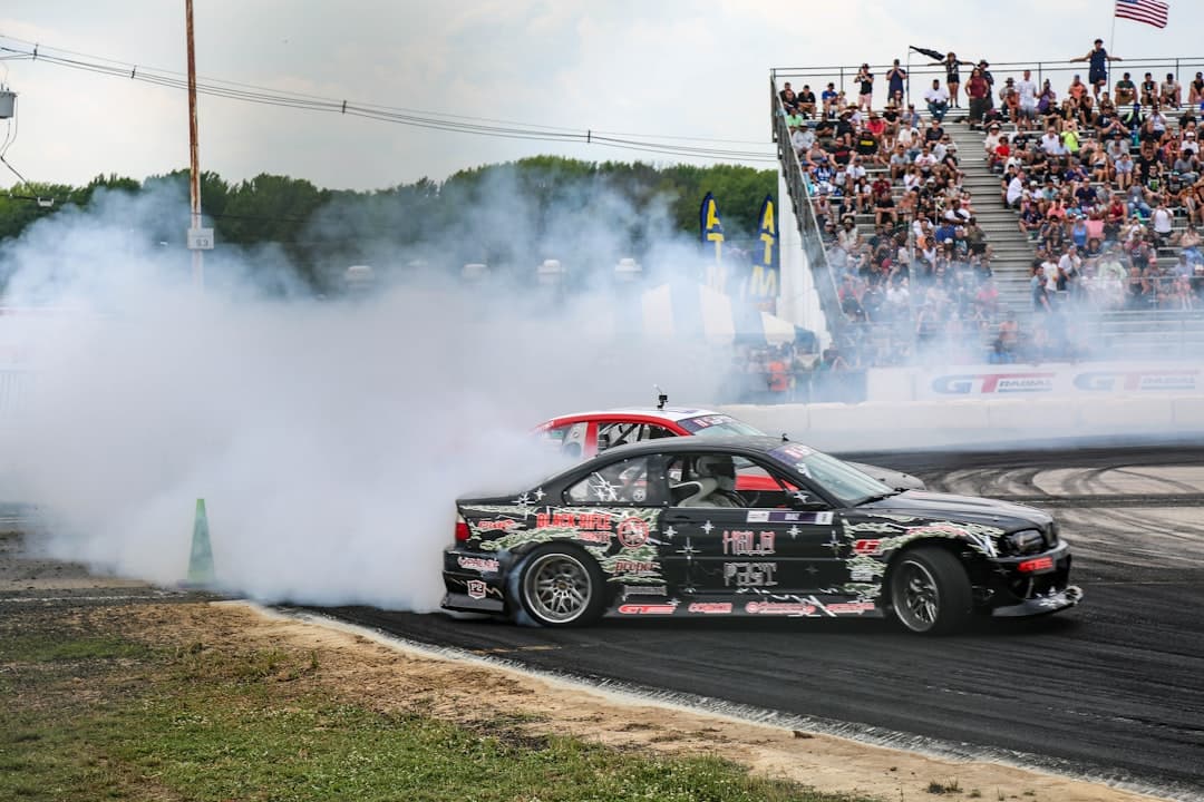 black and red racing car on road