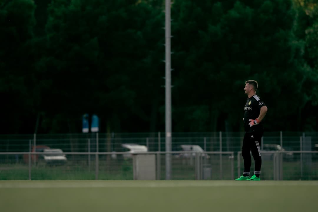 a man standing on top of a soccer field