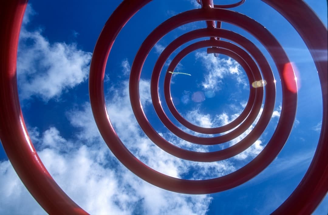 a metal sculpture with a sky in the background