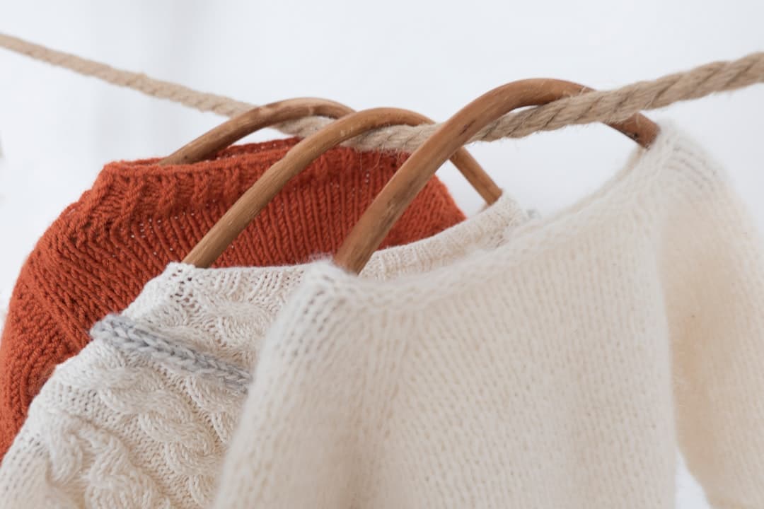 a couple of sweaters hanging on a clothes line