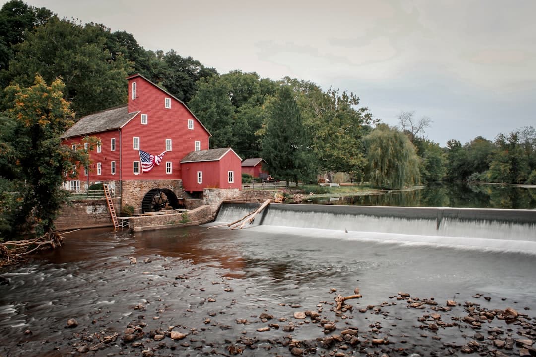 a red building sitting on top of a river