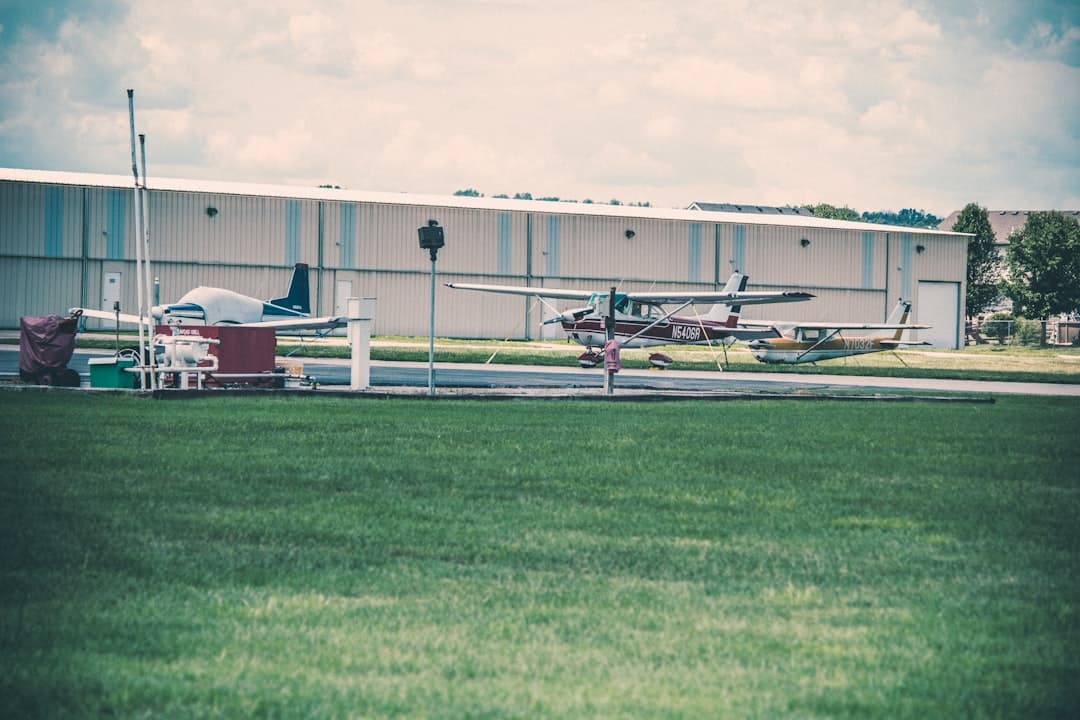 a small plane parked in front of a hangar