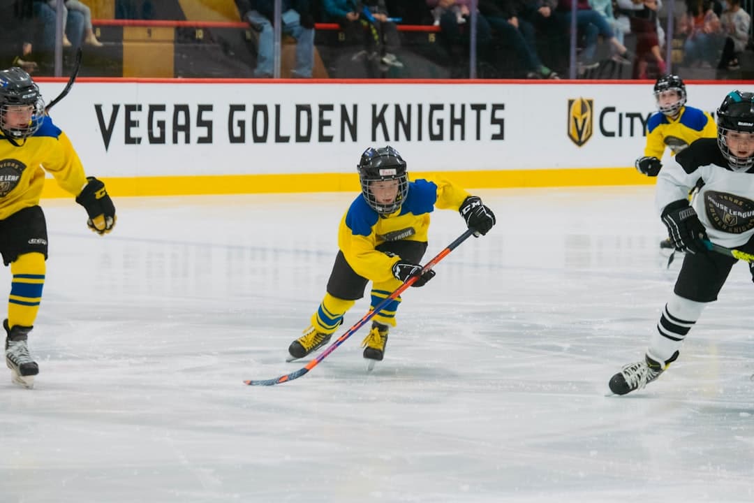 a group of young men playing a game of ice hockey