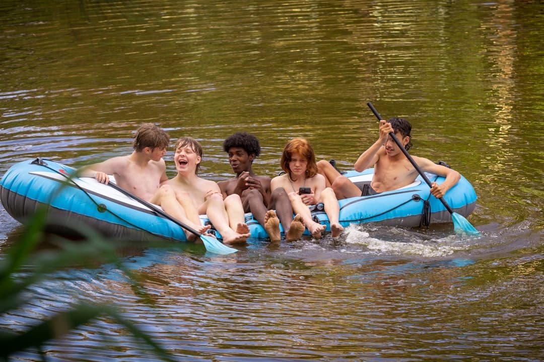 a group of people riding on the back of a raft