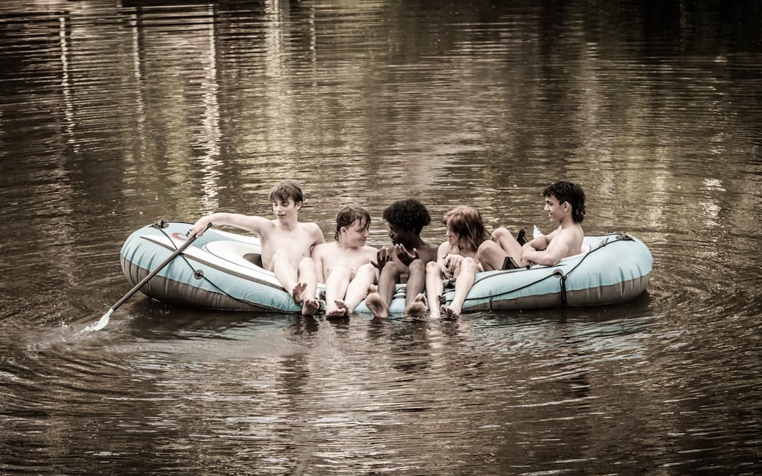 a group of people riding on top of a raft in a body of water