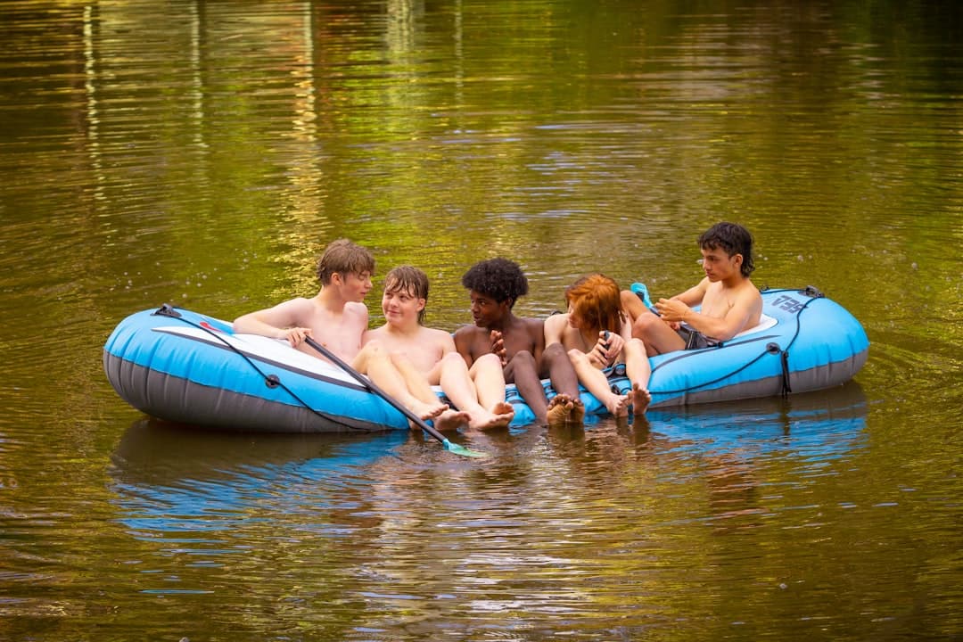 a group of people floating on top of a raft in a body of water
