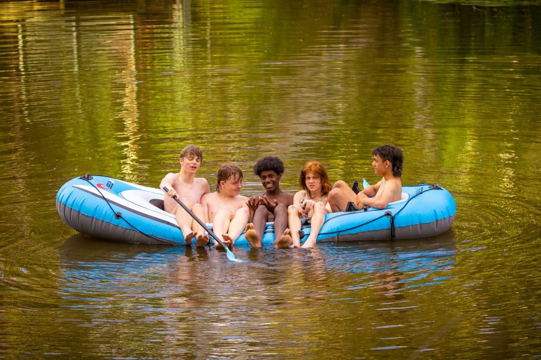 a group of people riding on top of a raft in the water