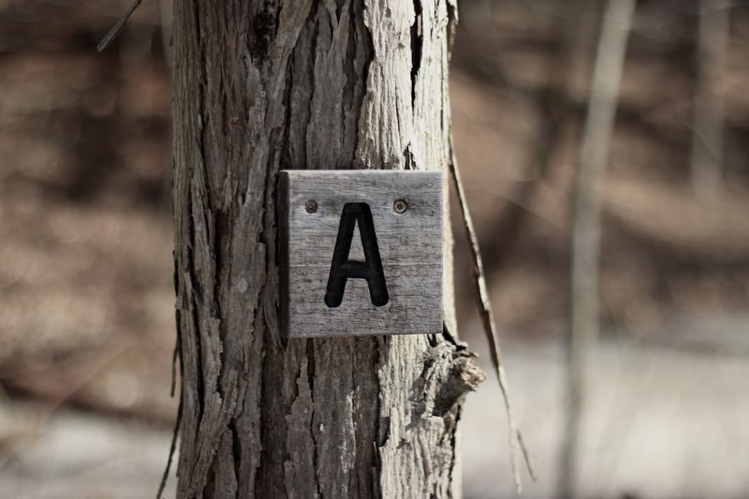 a sign that is on a tree in the woods