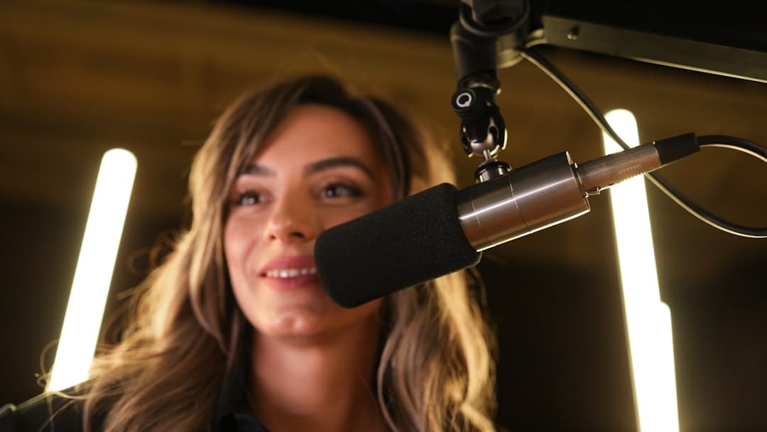 a woman in a recording studio with a microphone