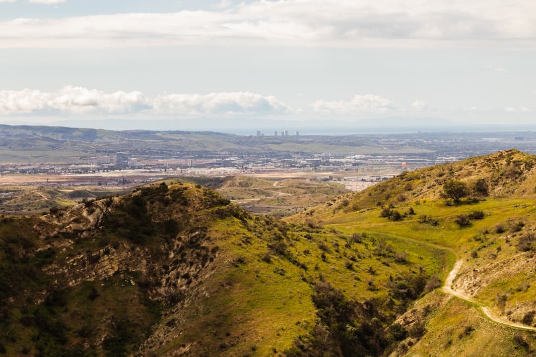 a scenic view of a valley and a city in the distance