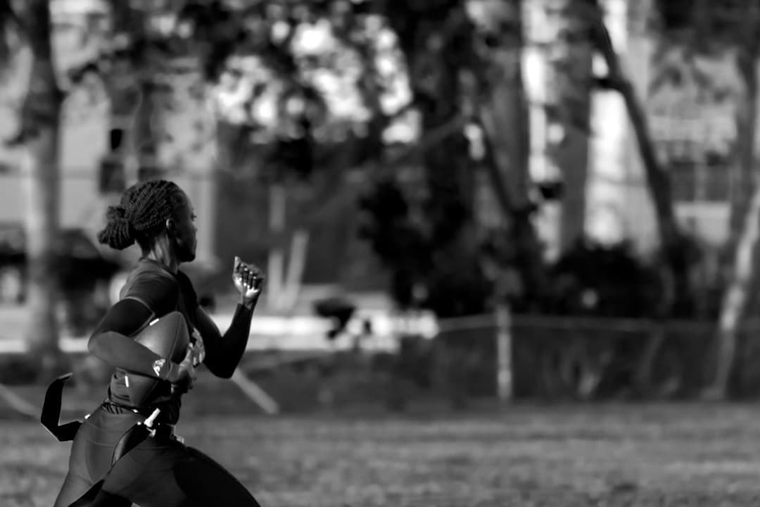 a black and white photo of a woman running