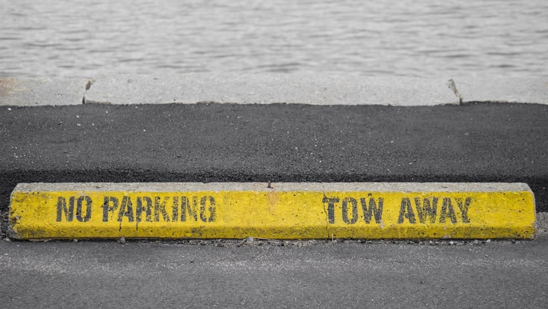 a no parking tow away sign on the side of the road