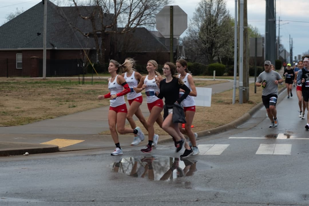 a group of people running down a street