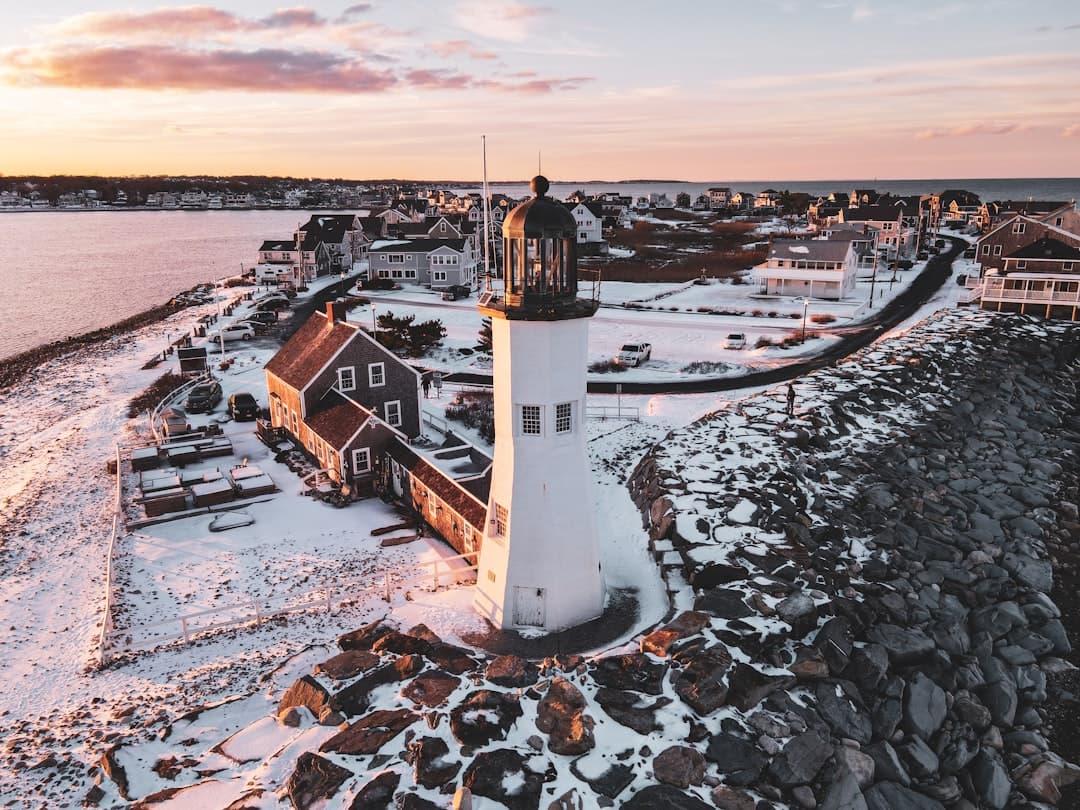 an aerial view of a lighthouse on a snowy day