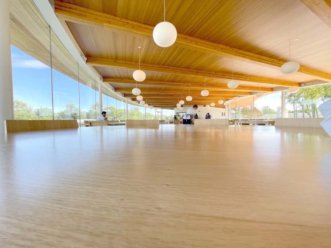 a large room with a wooden ceiling and white walls