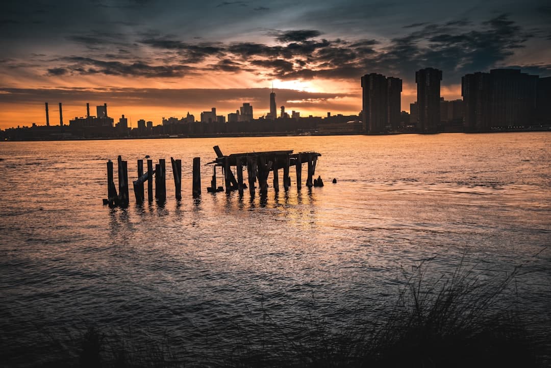 a city skyline seen from across the water at sunset