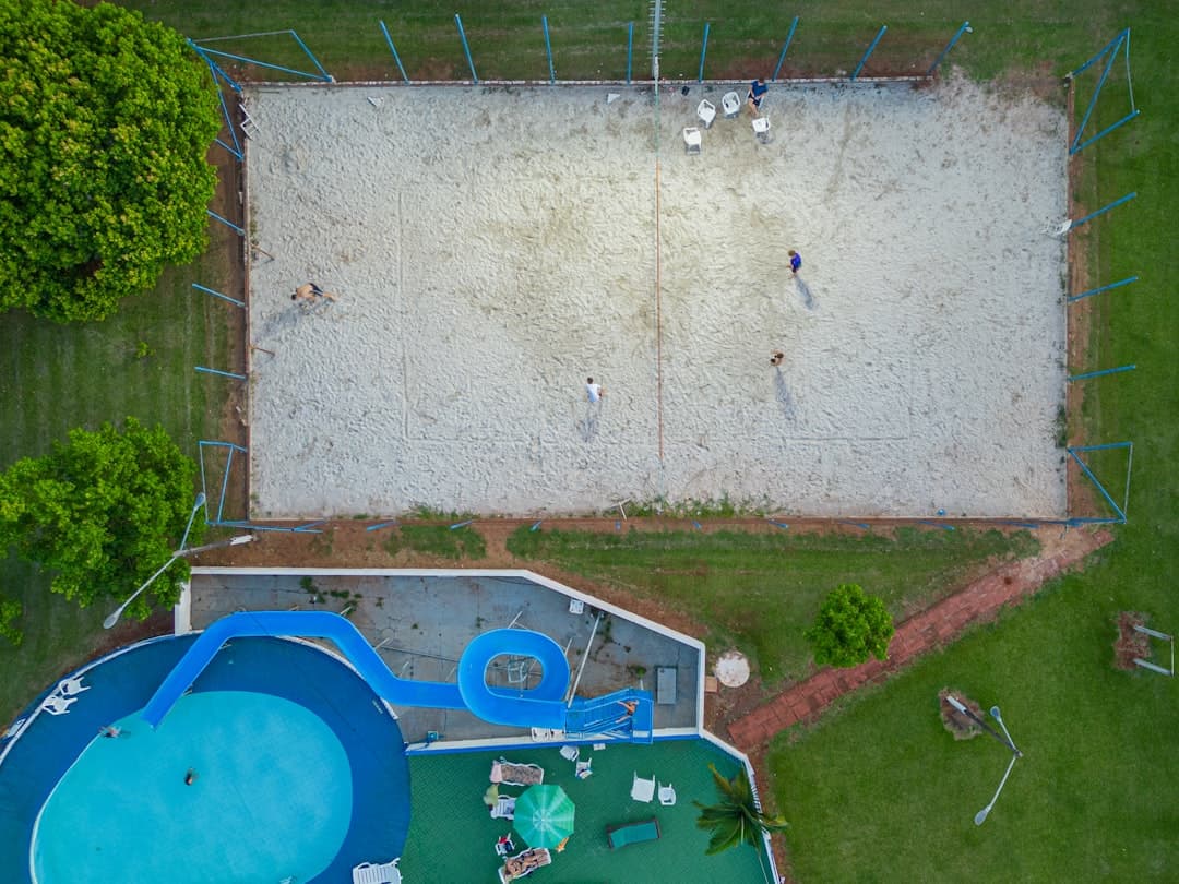 an overhead view of a playground with a pool