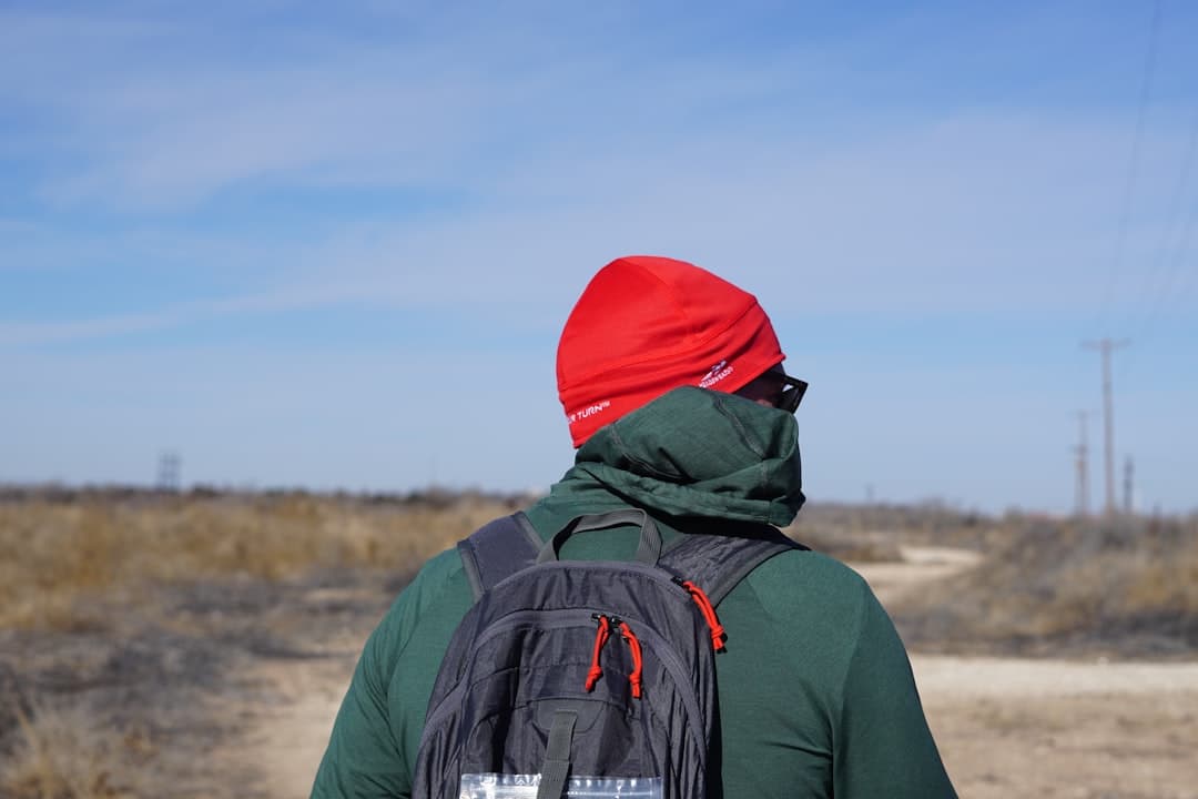 a person with a backpack on a dirt road
