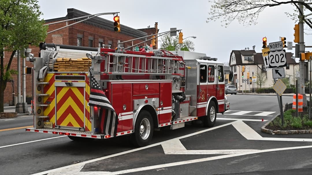 a red fire truck driving down a street