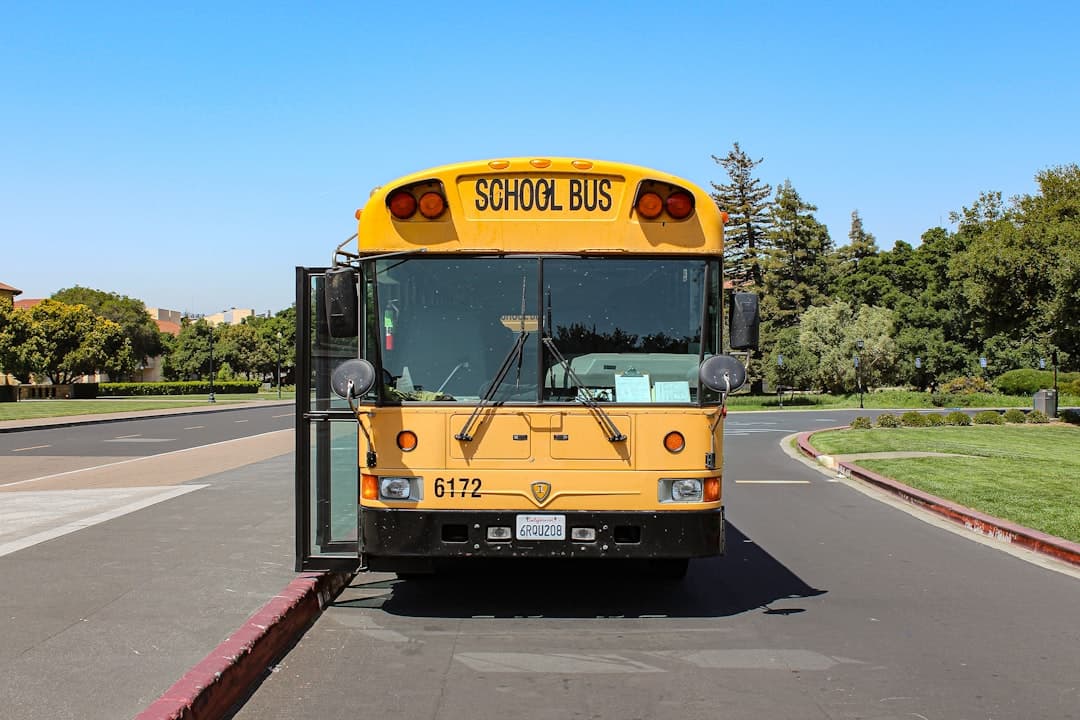 a yellow school bus driving down a street