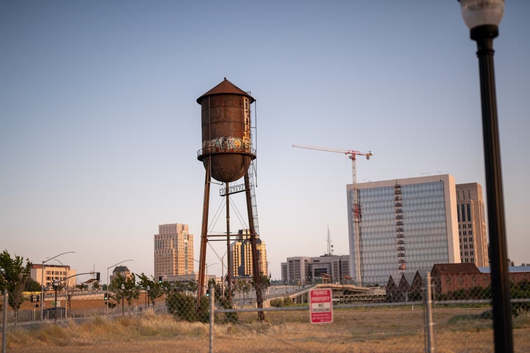 a tall water tower sitting in the middle of a field