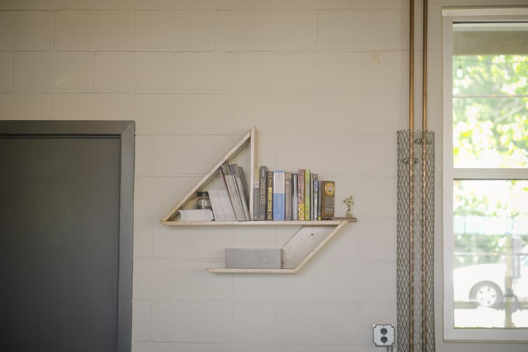 a bookshelf with books on it next to a door