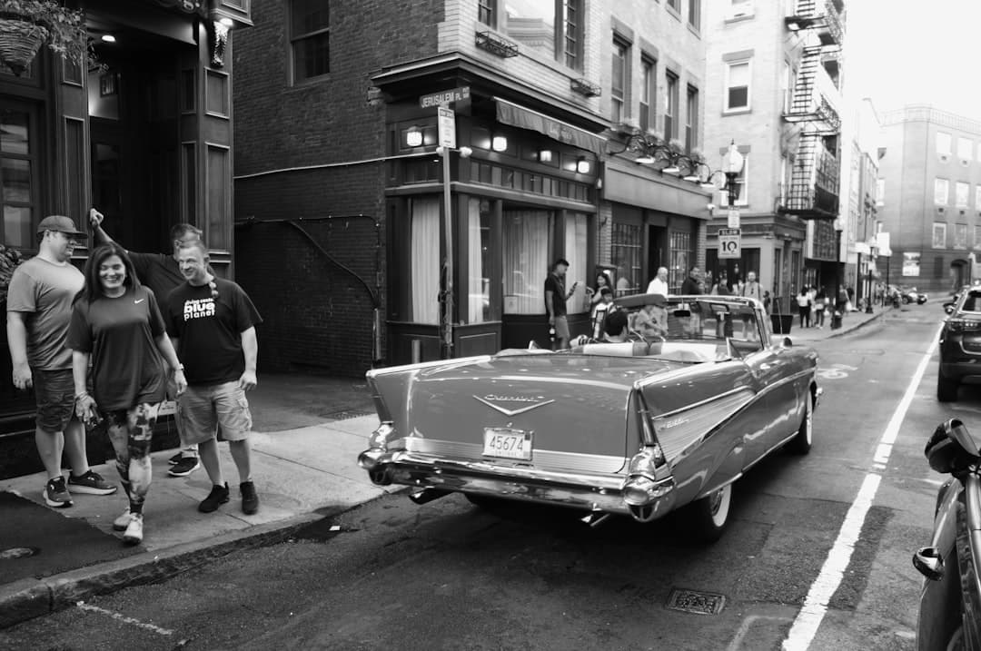 a black and white photo of a car parked on the side of the road