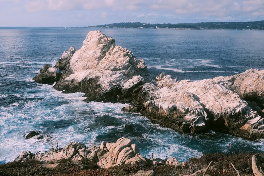 a large rock sticking out of the ocean