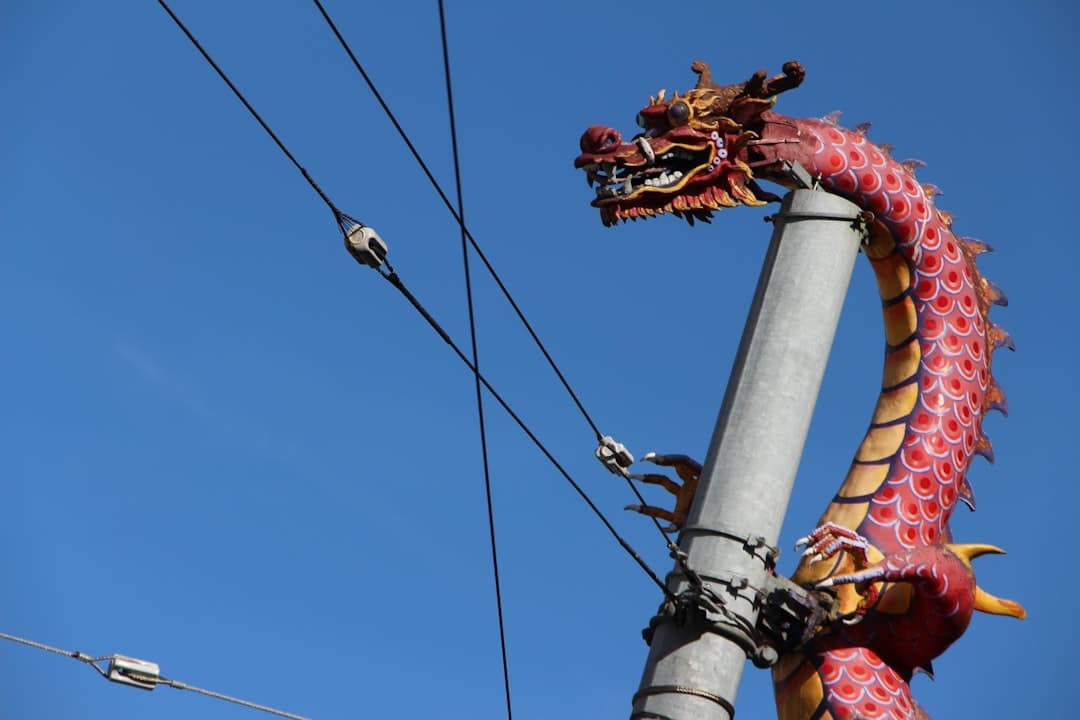 a dragon statue on top of a metal pole