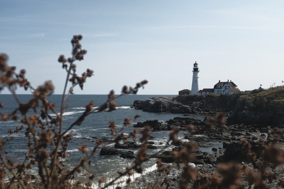 a light house sitting on top of a cliff next to the ocean