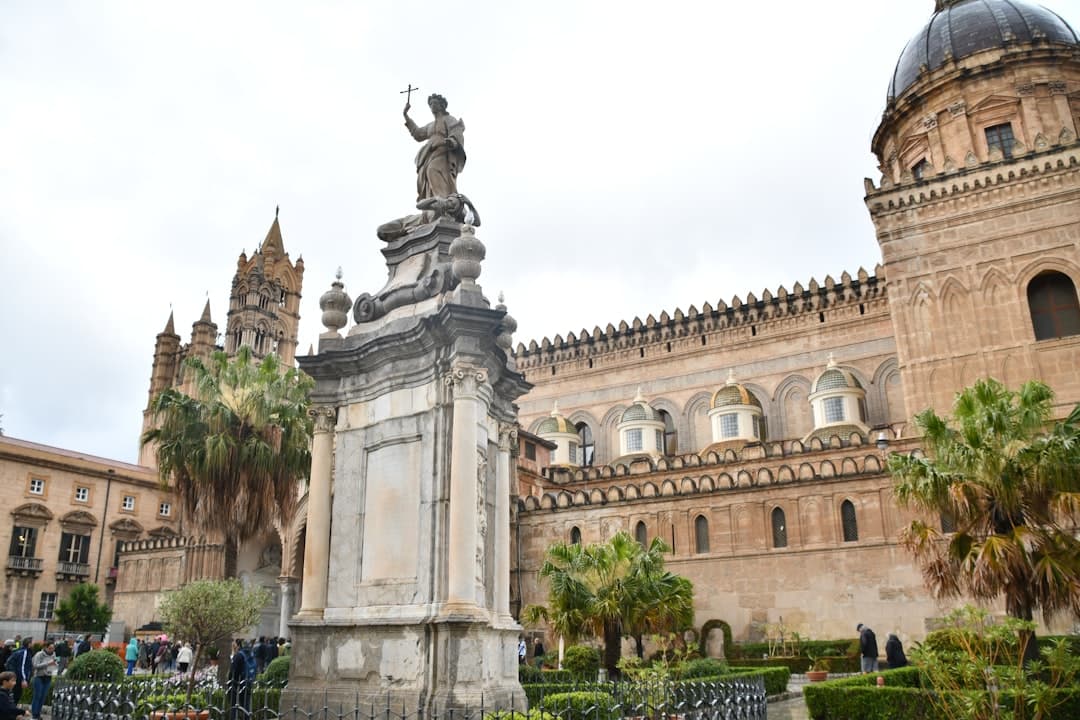 a statue in front of a large building