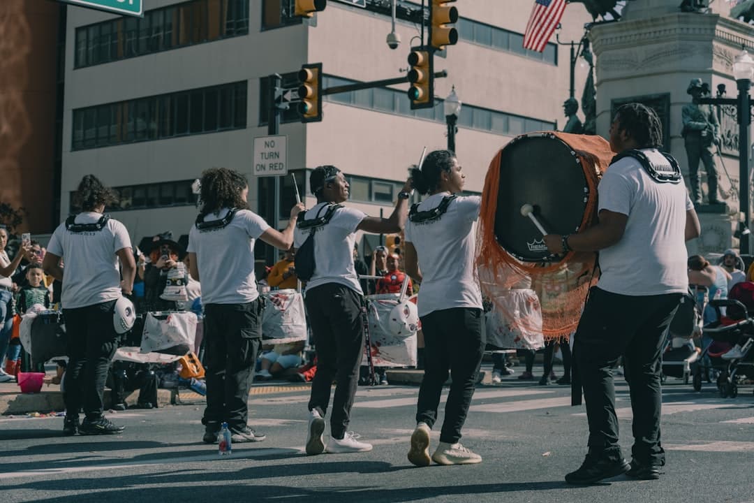 a group of people standing on the side of a road