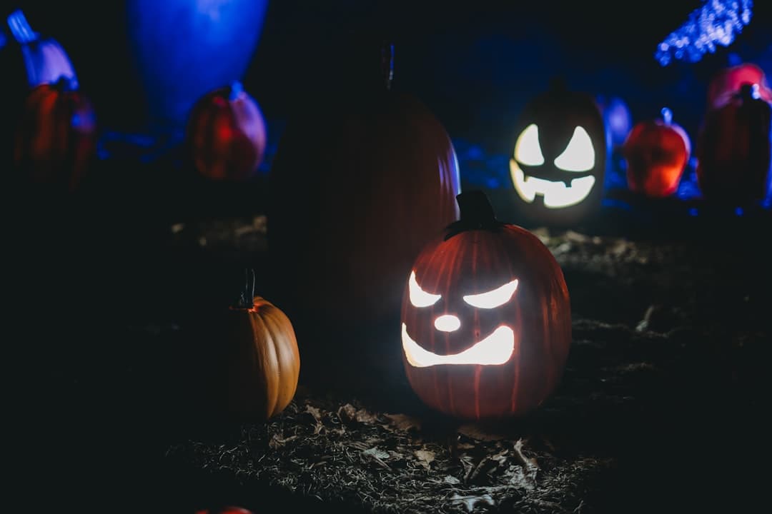 a group of carved pumpkins sitting on top of a field