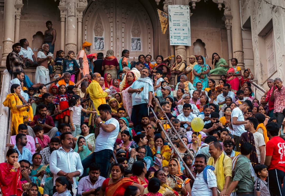 a crowd of people sitting on the steps of a building