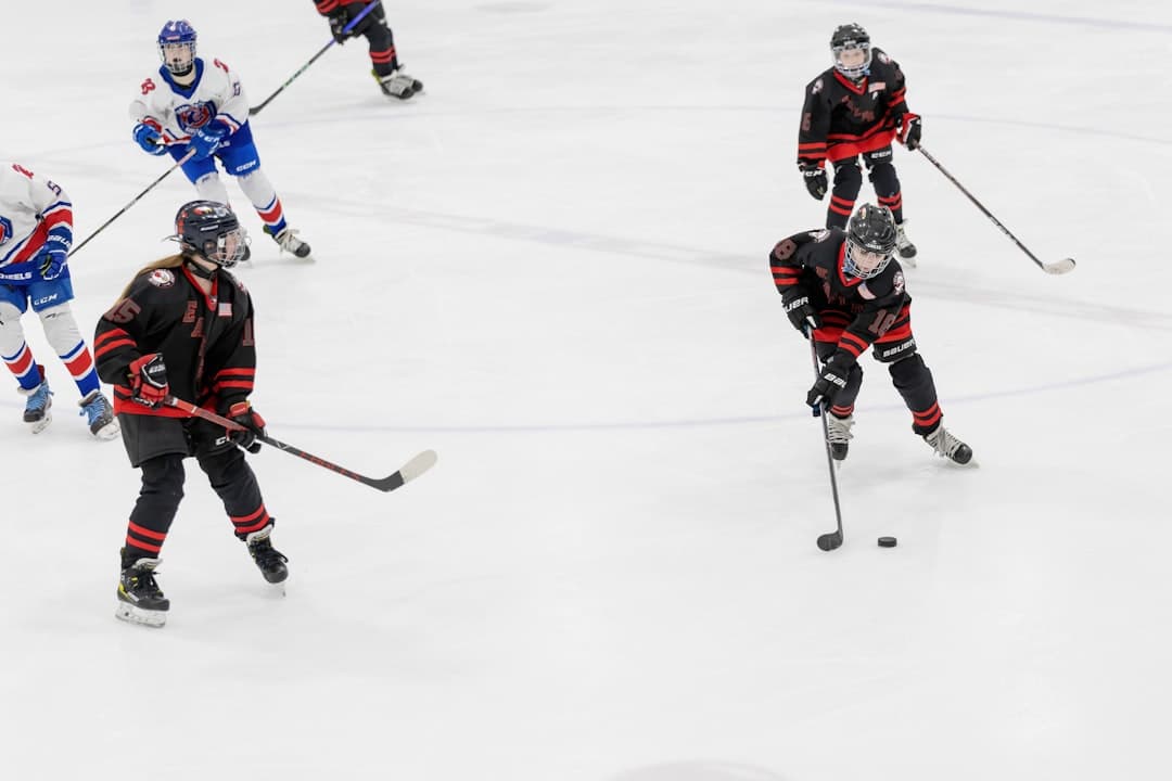 a group of young men playing a game of ice hockey