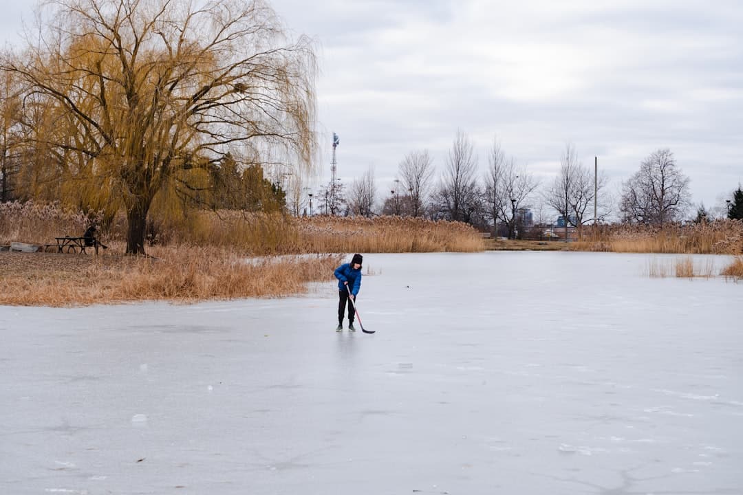 a man standing on top of a frozen lake