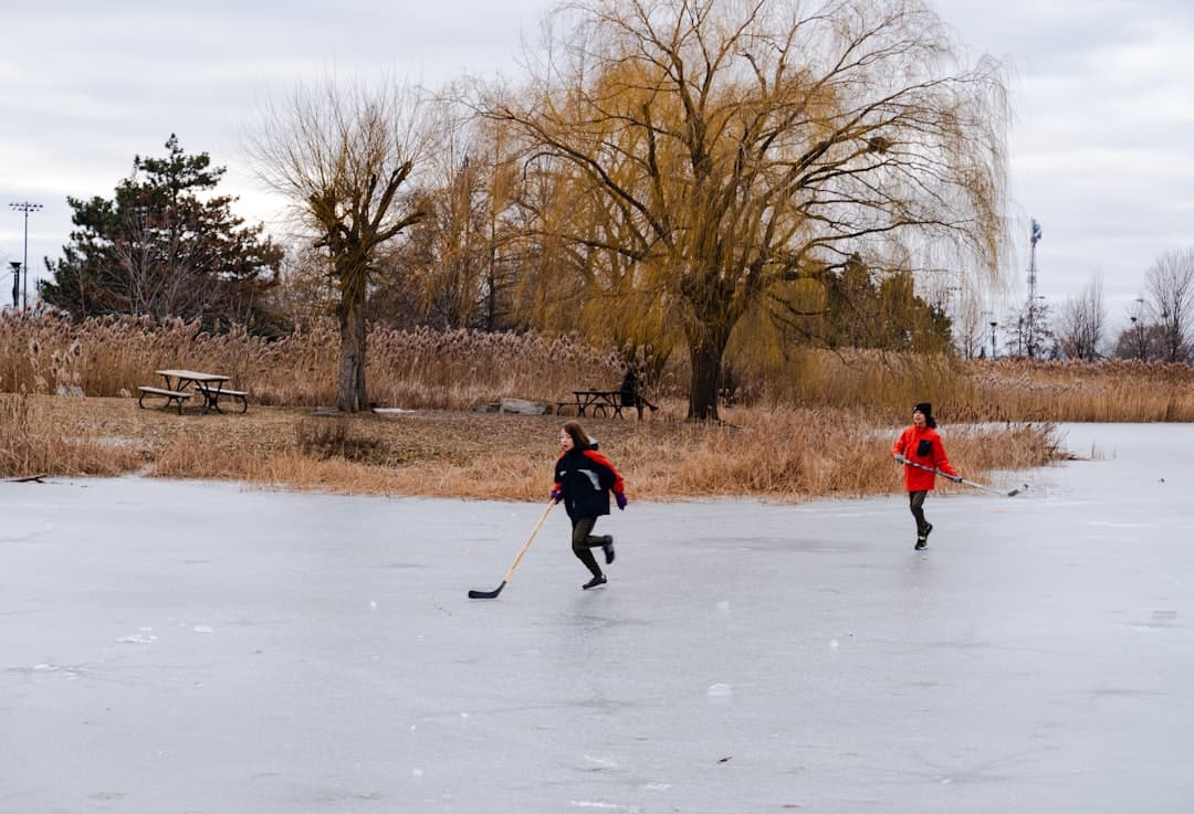 a couple of people playing a game of ice hockey