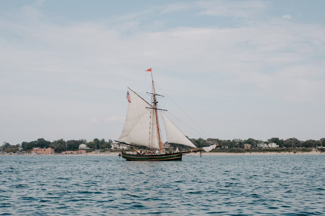 a sailboat sailing on a body of water