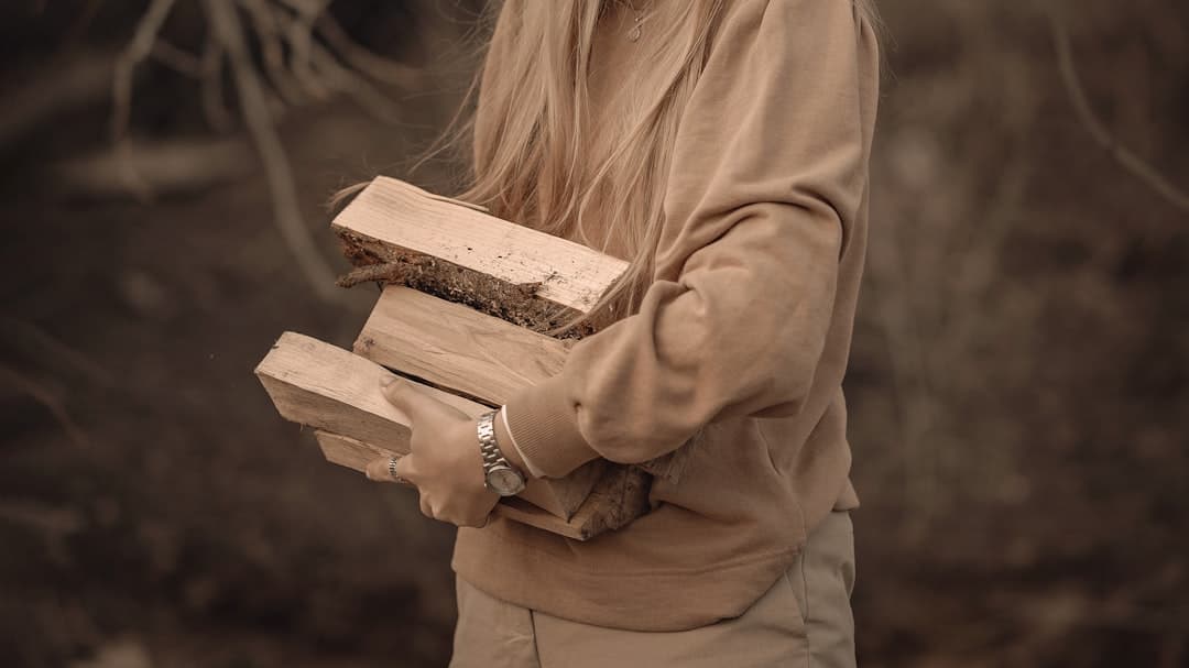 a woman holding two wooden blocks of wood