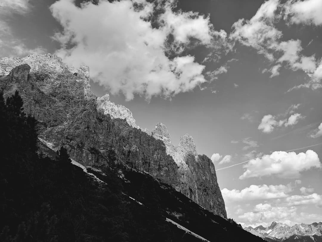 a black and white photo of mountains and clouds