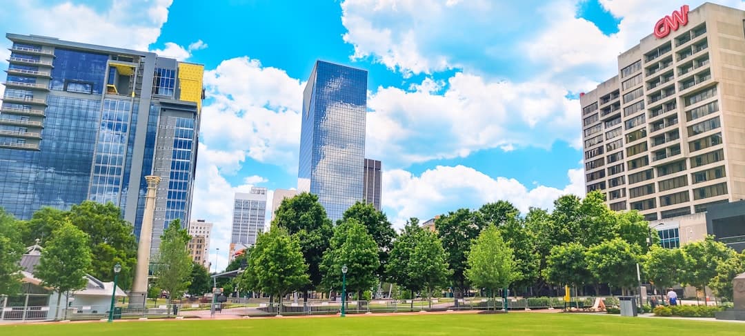 a city park with tall buildings in the background